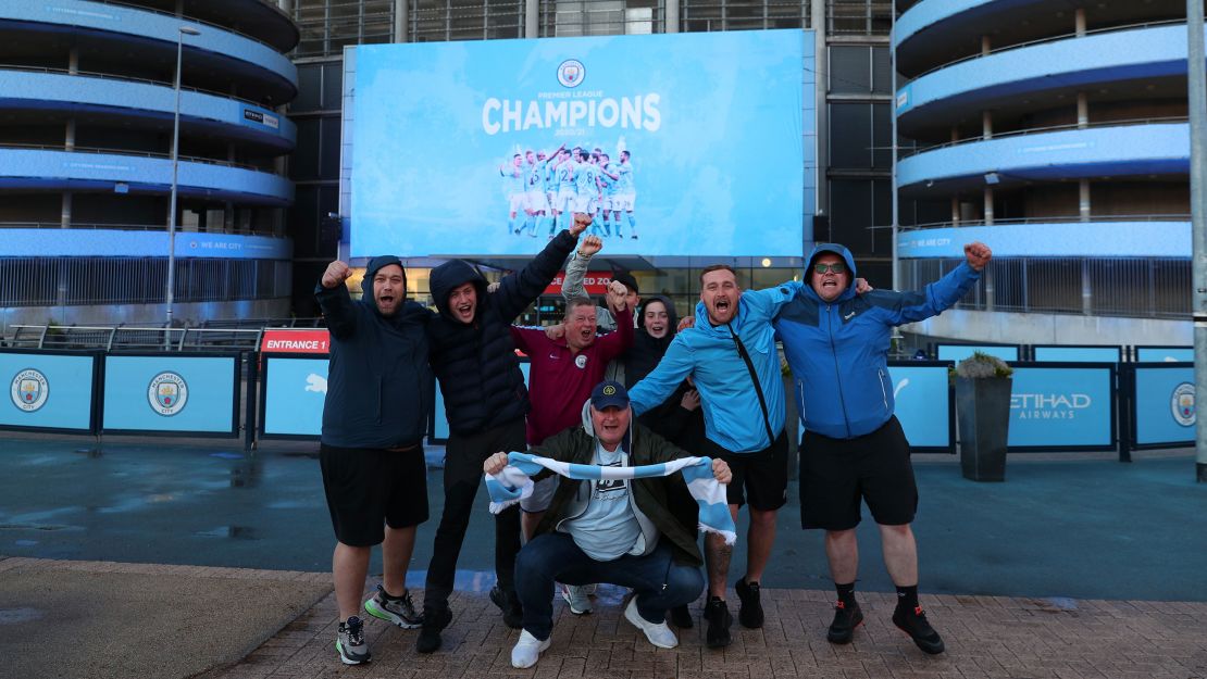 Fans celebrate at the Etihad Stadium after Manchester City was crowned Premier League champion.