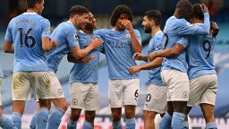 Manchester City's English midfielder Raheem Sterling (3rd L) celebrates with teammates after scoring the opening goal of the English Premier League football match between Manchester City and Chelsea at the Etihad Stadium in Manchester, north west England, on May 8, 2021. - RESTRICTED TO EDITORIAL USE. No use with unauthorized audio, video, data, fixture lists, club/league logos or 'live' services. Online in-match use limited to 120 images. An additional 40 images may be used in extra time. No video emulation. Social media in-match use limited to 120 images. An additional 40 images may be used in extra time. No use in betting publications, games or single club/league/player publications. (Photo by Shaun Botterill / POOL / AFP) / RESTRICTED TO EDITORIAL USE. No use with unauthorized audio, video, data, fixture lists, club/league logos or 'live' services. Online in-match use limited to 120 images. An additional 40 images may be used in extra time. No video emulation. Social media in-match use limited to 120 images. An additional 40 images may be used in extra time. No use in betting publications, games or single club/league/player publications. / RESTRICTED TO EDITORIAL USE. No use with unauthorized audio, video, data, fixture lists, club/league logos or 'live' services. Online in-match use limited to 120 images. An additional 40 images may be used in extra time. No video emulation. Social media in-match use limited to 120 images. An additional 40 images may be used in extra time. No use in betting publications, games or single club/league/player publications. (Photo by SHAUN BOTTERILL/POOL/AFP via Getty Images)