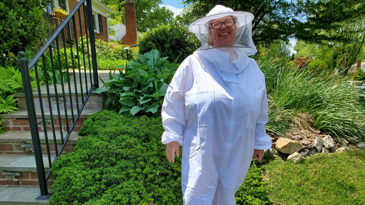 Michelle Matlack of Annandale, Virginia, hopes her beekeeping suit will protect her from stray cicadas.