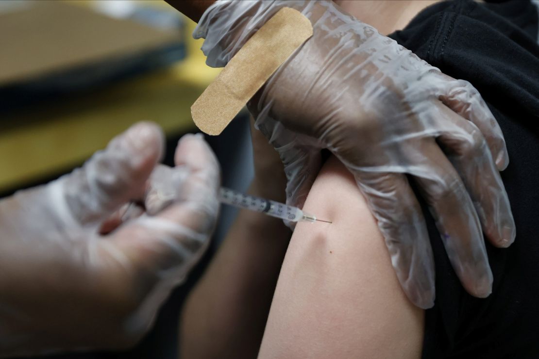 A teen receives  Pfizer's vaccine   at Dekalb Pediatric Center in Decatur, Georgia, on Tuesday.  