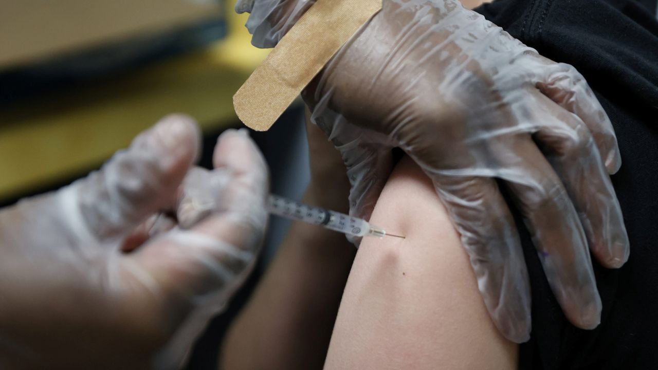 A teenager is inoculated with Pfizer's vaccine against coronavirus disease (COVID-19) after Georgia authorized the vaccine for ages over 12 years, at Dekalb Pediatric Center in Decatur, Georgia, U.S. May 11, 2021.   REUTERS/Chris Aluka Berry