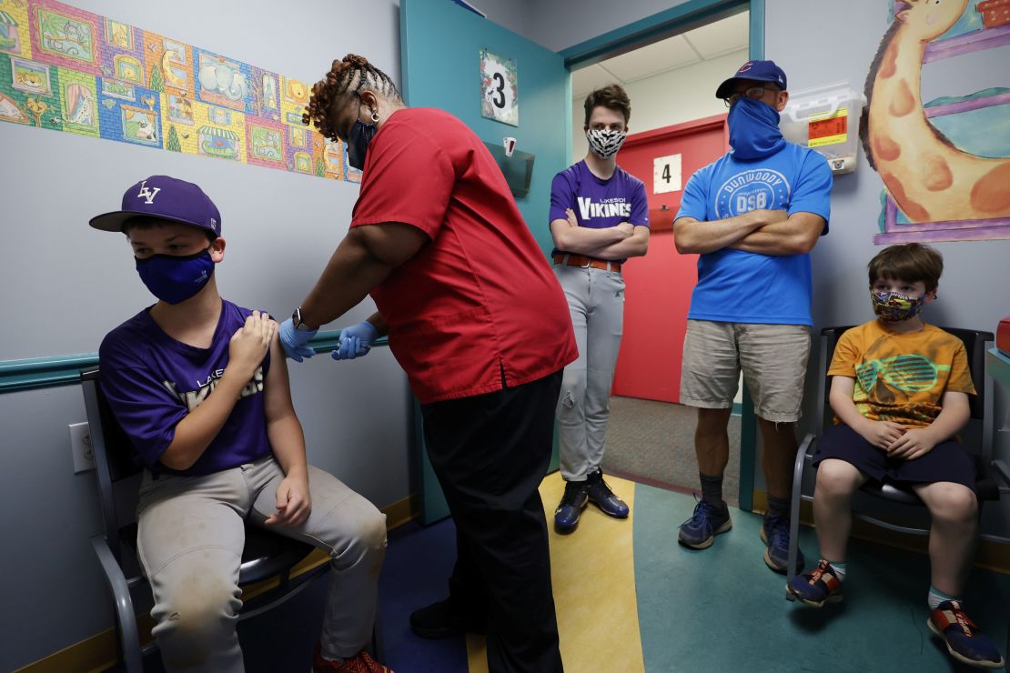 Family members look on as Jack Frilingos, 12, is vaccinated May 11 in Decatur, Georgia.