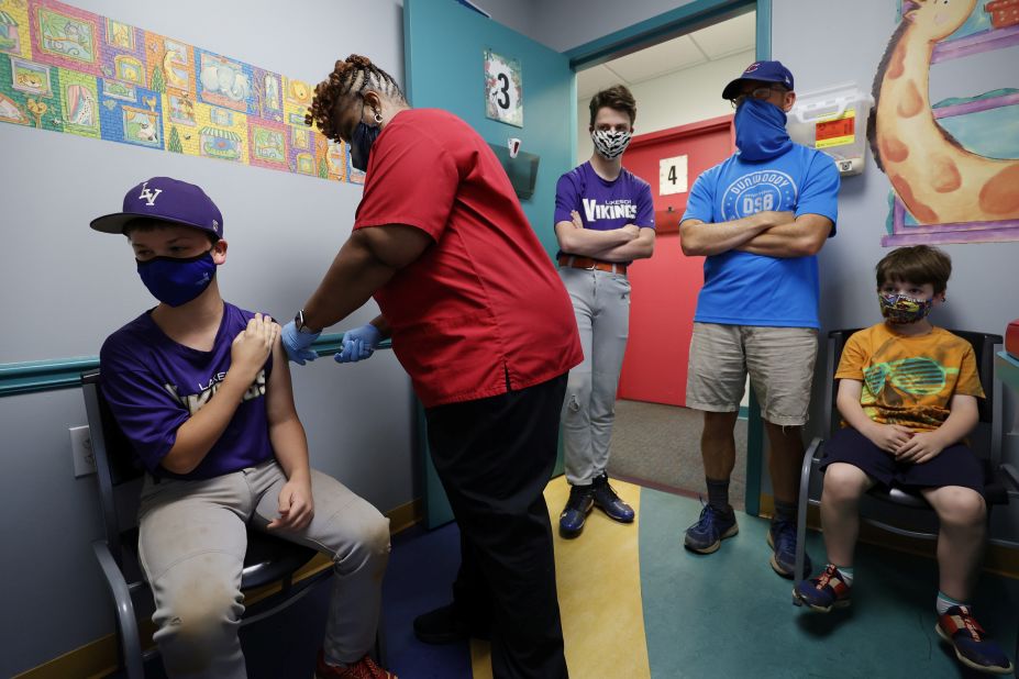 Family members look on as Jack Frilingos, 12, receives a Covid-19 vaccine in Decatur, Georgia, on May 11. It was a day after the US Food and Drug Administration <a href="https://www.cnn.com/2021/05/11/health/us-coronavirus-tuesday/index.html" target="_blank">authorized Pfizer's vaccine for the 12-15 age group.</a>