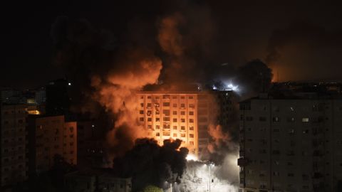 Smoke caused by Israeli airstrikes are seen at a residential building in Gaza City.
