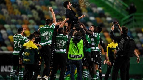 Players toss Sporting's head coach Ruben Amorim into the air after winning  the league title. 