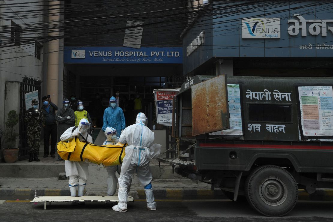 Nepali Army personnel load the body of a Covid-19 victim into a van to be taken to a crematorium.