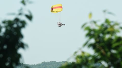 A staff member uses a powered parachute to search for an escaped leopard in the mountains near Hejia Village in the West Lake District of Hangzhou, capital of east China's Zhejiang Province, May 9, 2021.