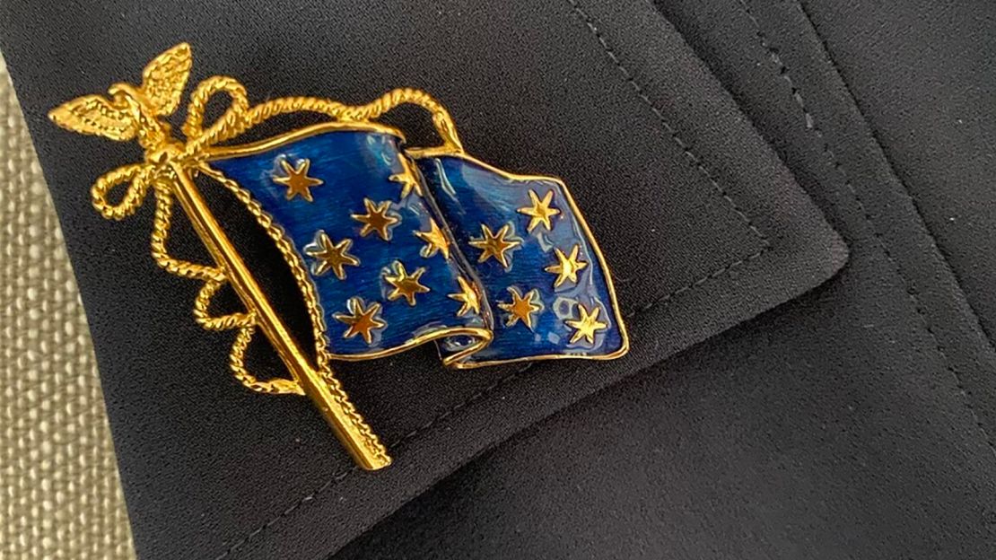 Liz Cheney's lapel pin depicts George Washington's traditional battle flag that is said to have flown over his headquarters during the Revolutionary War.
