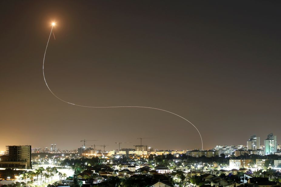 A streak of light is seen from Ashkelon, Israel, as Israel's Iron Dome system intercepts rockets launched from Gaza on May 11.