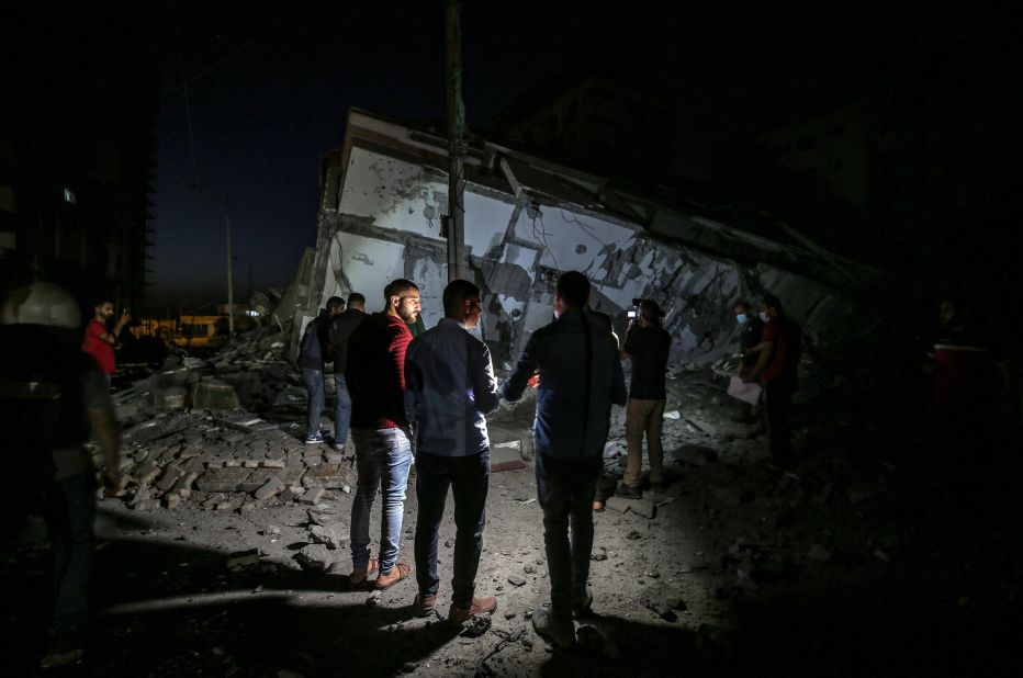 Palestinians inspect the rubble of the destroyed Hanadi tower after an Israeli airstrike in Gaza City on May 11.