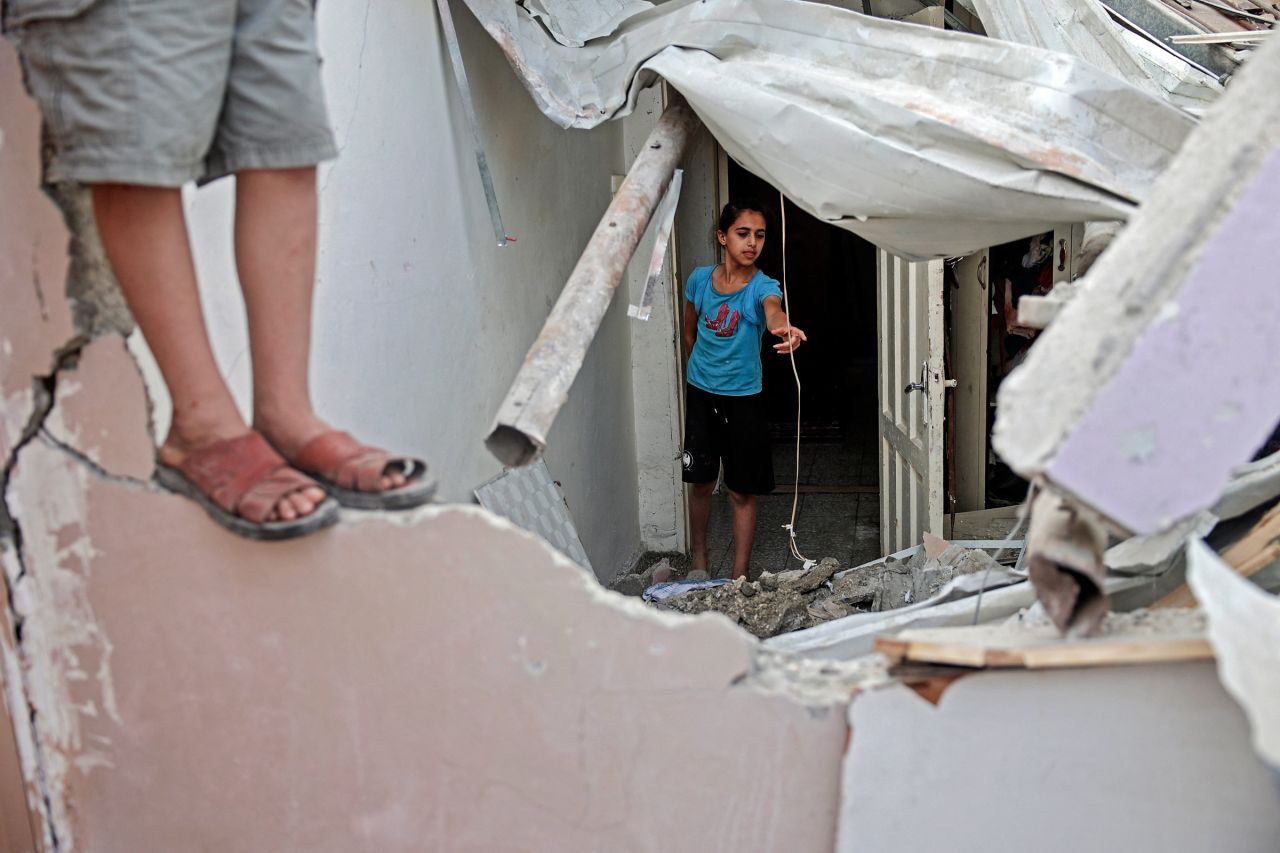 Palestinian children inspect a damaged bedroom following an Israeli airstrike at Gaza City's al-Shati Refugee Camp on May 11.