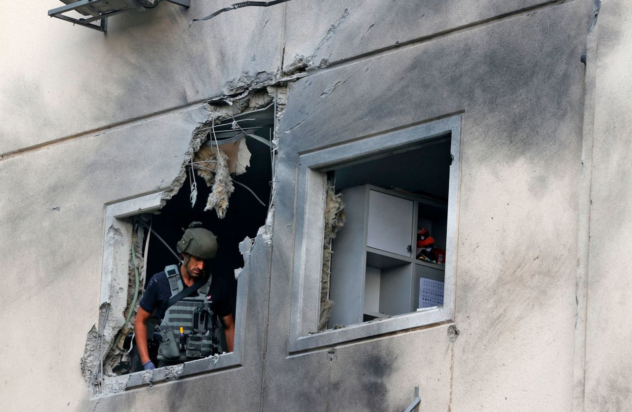 An Israeli soldier checks a damaged apartment building in Ashkelon on May 11.