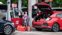 BENSON, NC - MAY 12:  A woman fills gas cans at a Speedway gas station on May 12, 2021 in Benson, North Carolina. Most stations in the area along I-95 are without fuel following the Colonial Pipeline hack. The 5,500 mile long pipeline delivers a large percentage of fuel on the East Coast from Texas up to New York. (Photo by Sean Rayford/Getty Images)