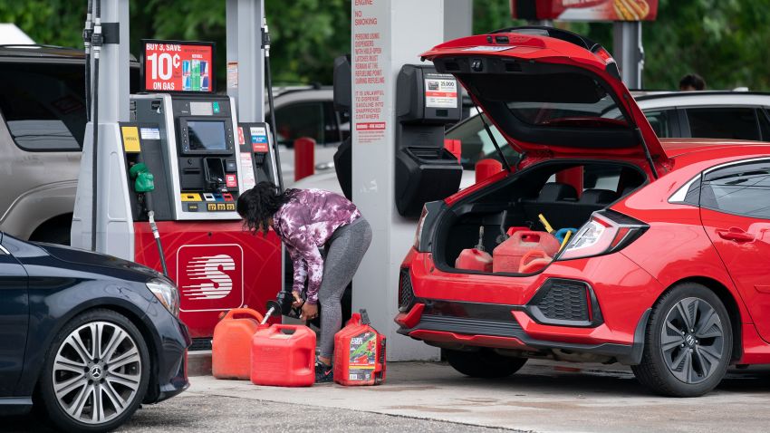 BENSON, NC - MAY 12: A woman fills gas cans at a Speedway gas station on May 12, 2021 in Benson, North Carolina. Most stations in the area along I-95 are without fuel following the Colonial Pipeline hack. The 5,500 mile long pipeline delivers a large percentage of fuel on the East Coast from Texas up to New York. (Photo by Sean Rayford/Getty Images)