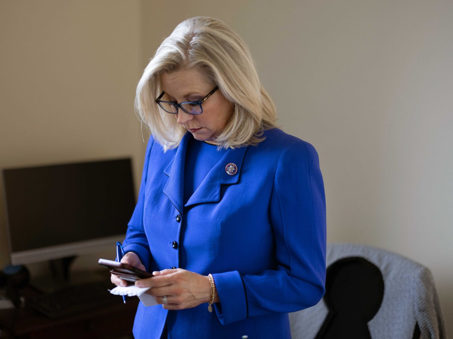 Cheney checks her messages after Wednesday's vote.
