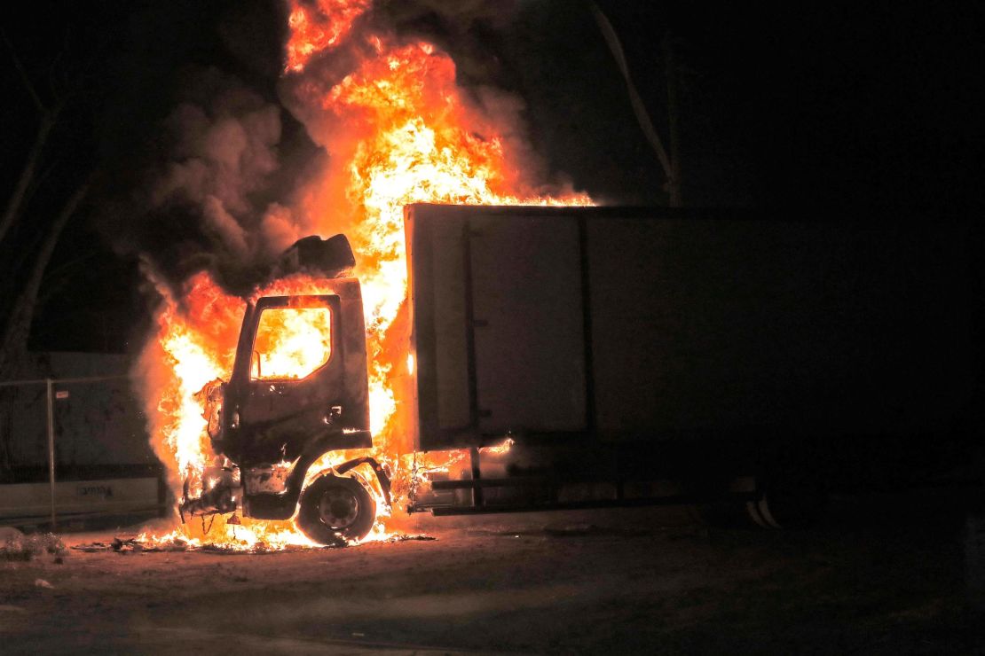 A truck burns near the entrance to the city of Lod.