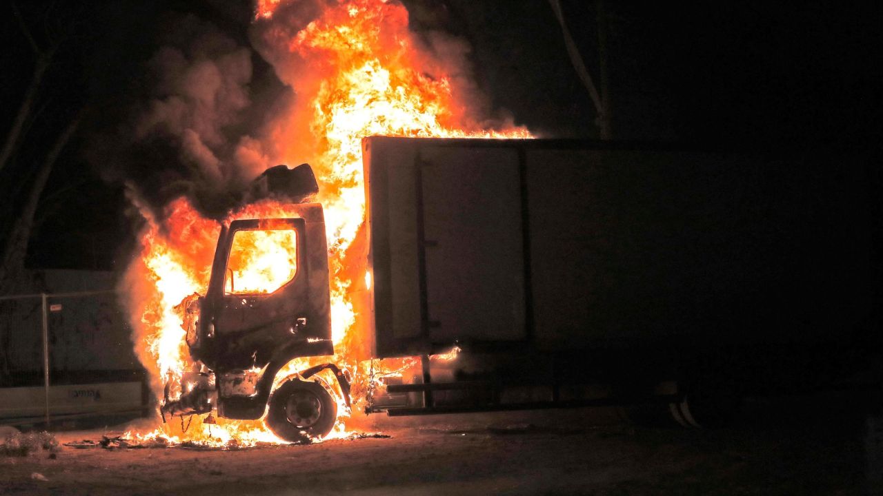 A truck burns near the entrance to the city of Lod.
