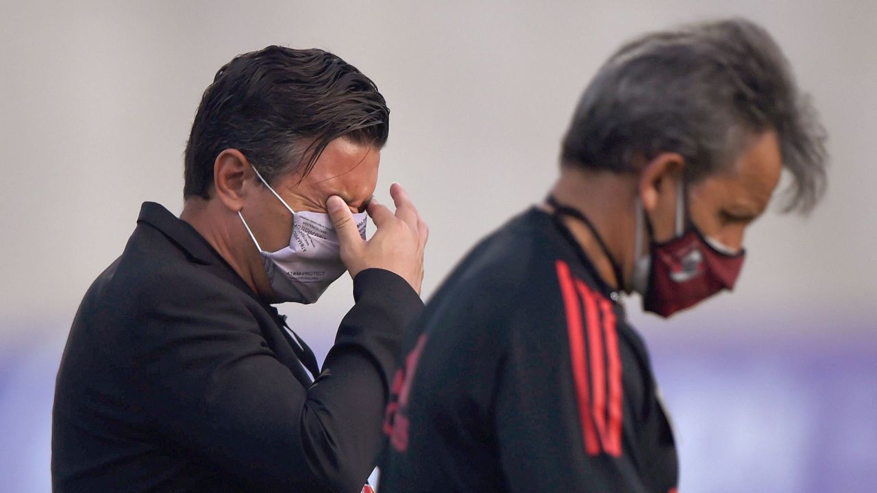 River Plate coach Marcelo Gallardo reacts to tear gas thrown outside the stadium.