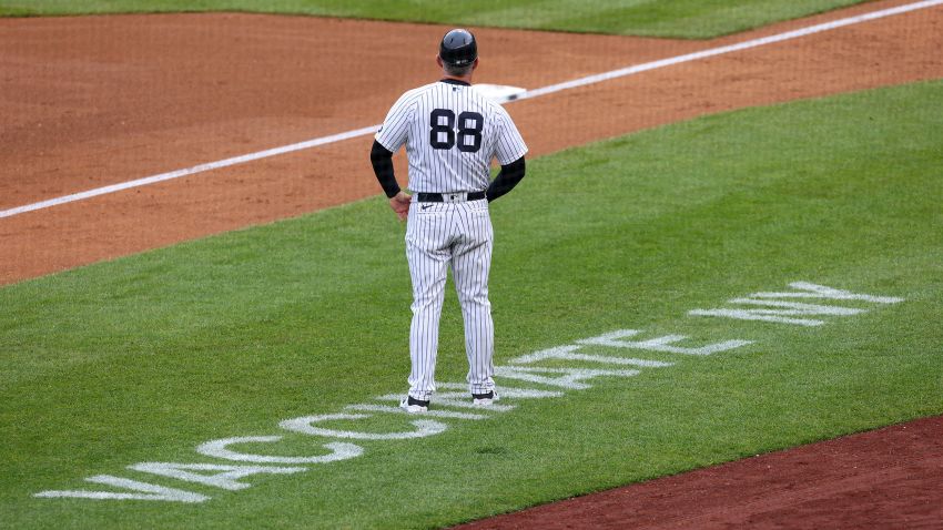 NEW YORK, NY - MAY 08: Third base coach Phil Nevin #88 of the New York Yankees stands near the coaching box as Vaccinate NY is painted on the field during a game against the Washington Nationals at Yankee Stadium on May 8, 2021 in New York City. A vaccination clinic is set up at the stadium for fans wishing to get vaccinated. (Photo by Rich Schultz/Getty Images)