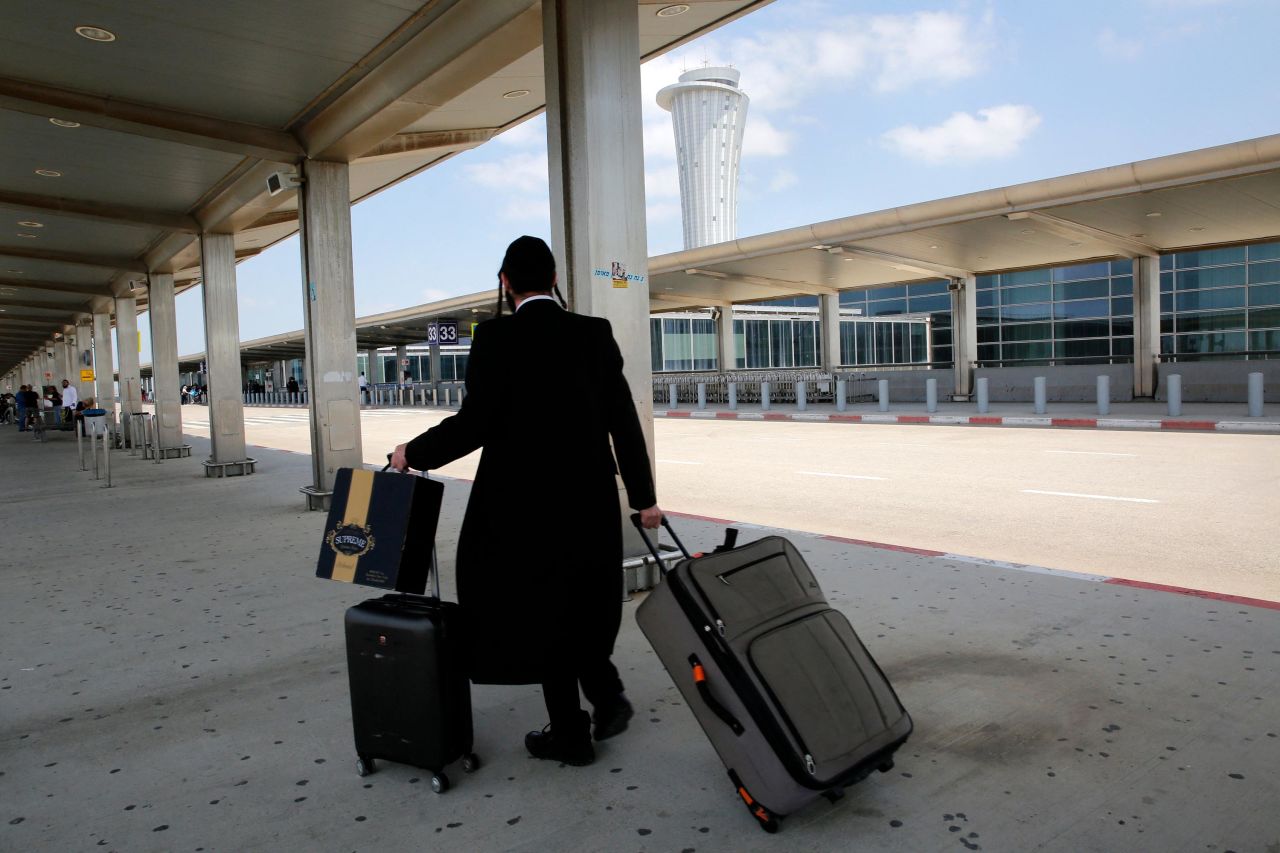 A passenger rolls his luggage at the nearly deserted Ben Gurion airport in Lod, Israel, on May 13. Global airlines were <a href="https://edition.cnn.com/2021/05/13/business/airlines-canceled-flights-israel/index.html" target="_blank">canceling flights to Israel</a> as clashes intensified between the country's military and Palestinian militants.