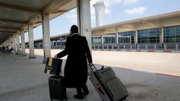 A departing passenger rolls his suitcases at the nearly deserted Ben Gurion airport in Lod, near the Israeli coastal city of Tel Aviv, on May 13, 2021. - Israel's civil aviation authority said it had diverted all incoming passenger flights headed for Ben Gurion airport to Ramon airport in the south, due to rocket fire from Gaza early in the morning. (Photo by GIL COHEN-MAGEN / AFP) (Photo by GIL COHEN-MAGEN/AFP via Getty Images)