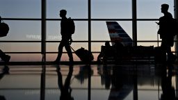 Travelers walk through Ronald Reagan National Airport (DCA) in Washington, D.C., U.S., on Wednesday, Nov. 21, 2018. 