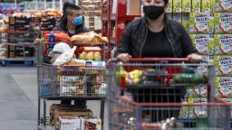 Shoppers wearing protective masks push shopping carts inside a Costco store in San Francisco, California, U.S., on Wednesday, March 3, 2021. Costco Wholesale Corp. is schedule to release earnings figures on March 4.