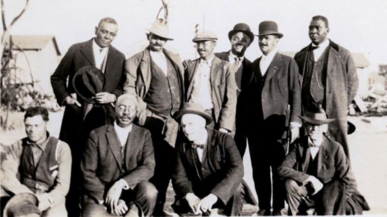 Originally from Arkansas, businessman <strong>Ottawa W. Gurley</strong> (front row, second from left) moved to Tulsa circa 1905 and bought 40 acres of land that he subdivided and sold to Black buyers. That, <a href="http://blackwallstreet.org/owgurley" target="_blank" target="_blank">followed by a grocery store and rooming house</a> that he built, helped enable other entrepreneurial Tulsans to move to the community and open up shop in Greenwood. 