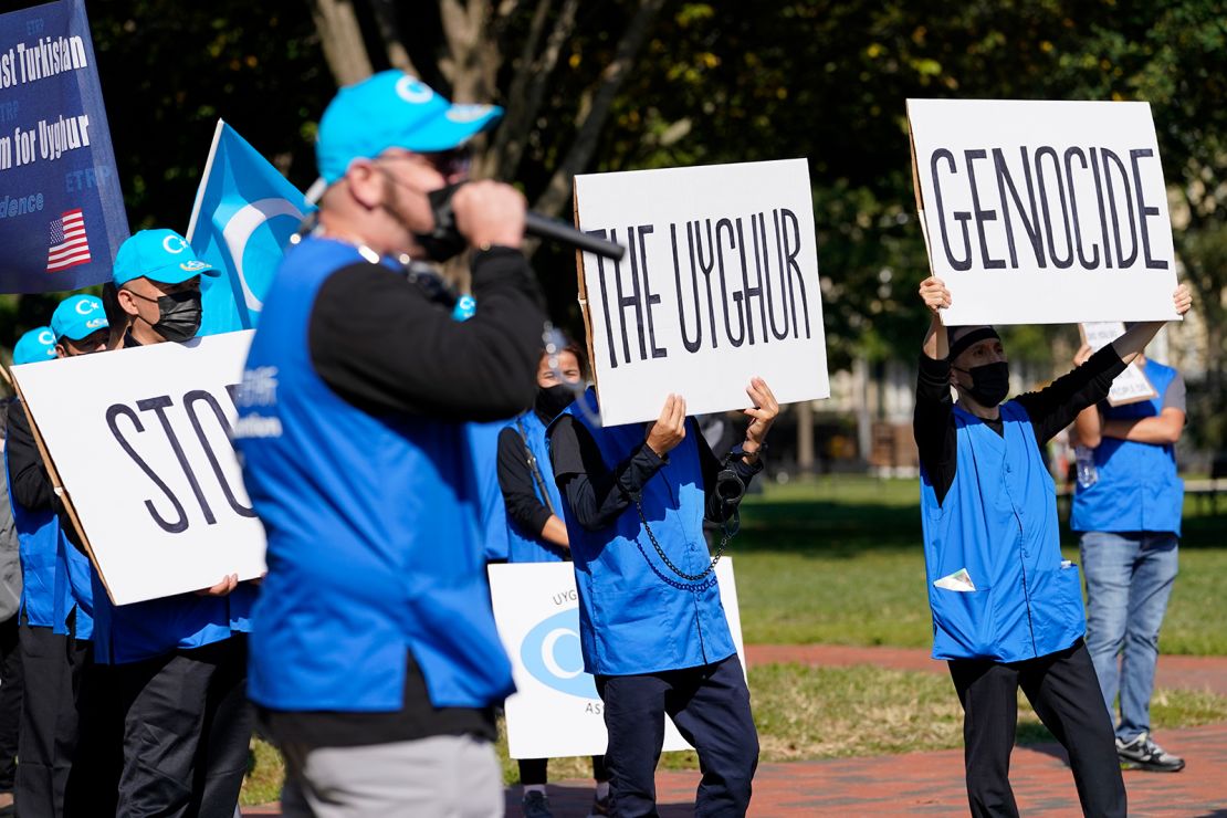 Holding signs saying "Stop the Uyghur Genocide," members of the Uyghur American Association rally in front of the White House, Thursday, Oct. 1, 2020.