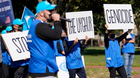 Holding signs saying "Stop the Uyghur Genocide," members of the Uyghur American Association rally in front of the White House, Thursday, Oct. 1, 2020.