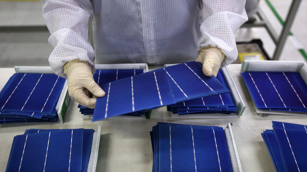 An employee performs a final inspection on solar cells on the production line at the Trina Solar Ltd. factory in Changzhou, Jiangsu Province, China in 2015. (Tomohiro Ohsumi/Bloomberg via Getty Images)