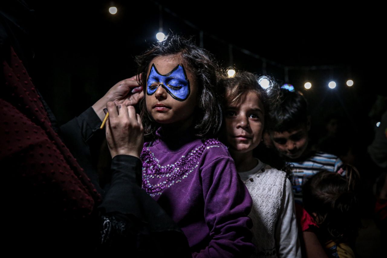 A child has her face painted during a gathering for a mass iftar (fast-breaking) meal in Aleppo, Syria, on May 6.