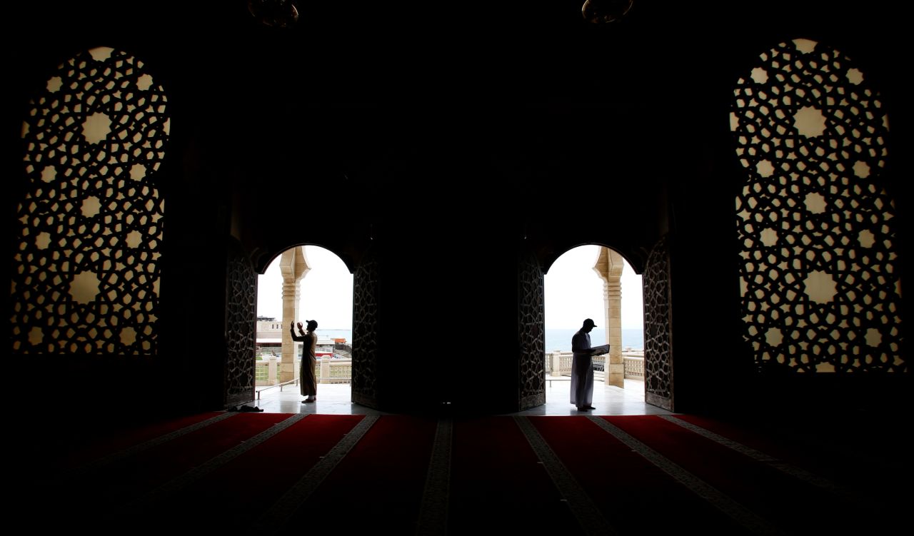 A man reads verses from the Quran at the Khaldi mosque in Gaza City on Saturday, May 9.