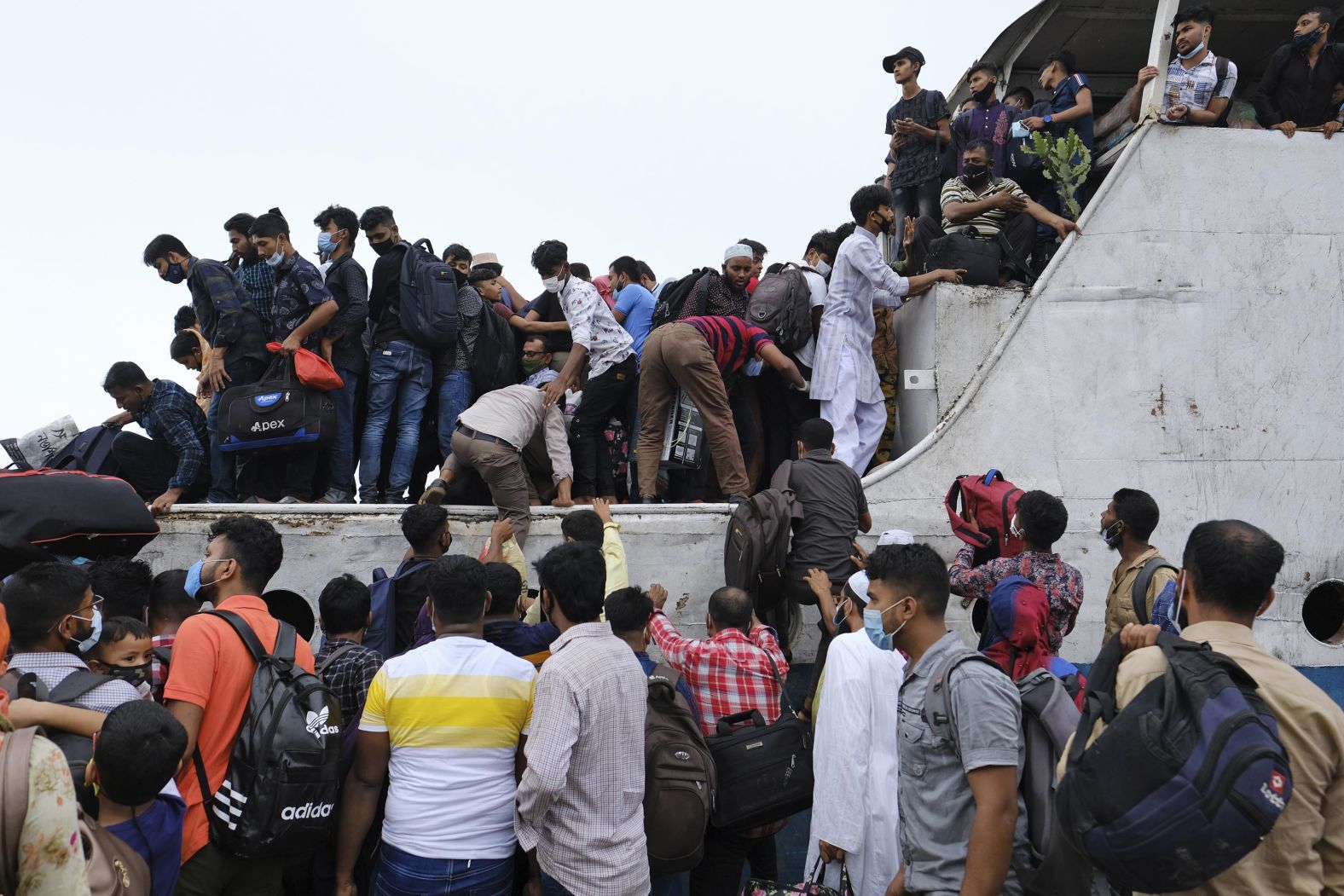 People traveling for Eid al-Fitr rush to a ferry terminal in Munshiganj, Bangladesh, on May 13.