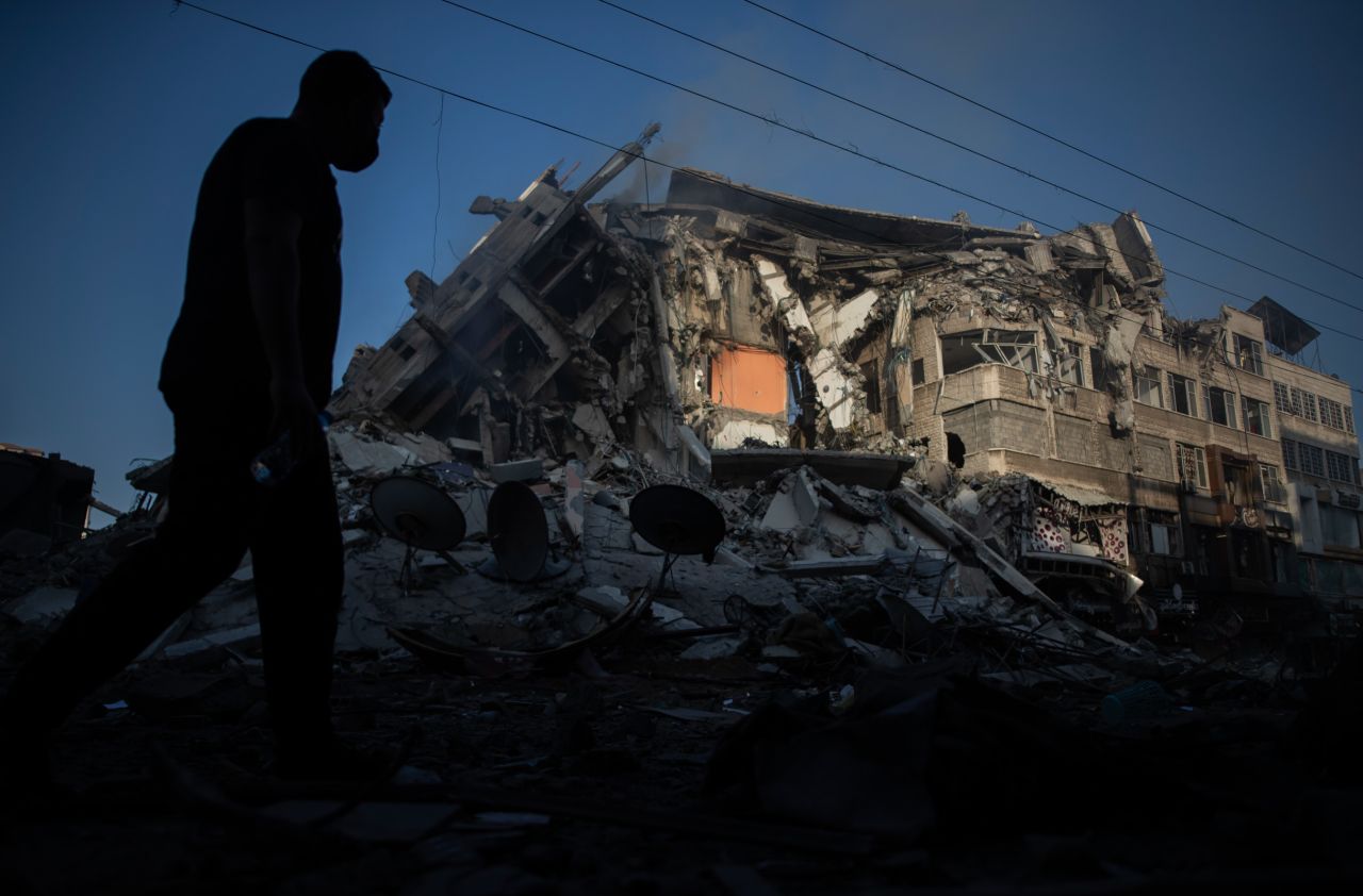 A Palestinian walks next to a building destroyed by Israeli airstrikes in Gaza City on May 13.