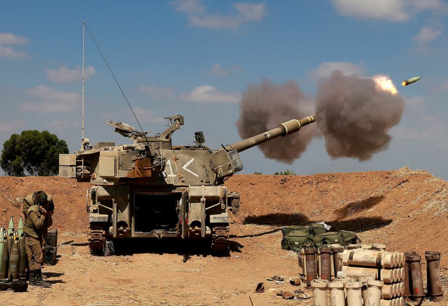 Israeli soldiers fire a self-propelled howitzer toward Gaza from their position near the southern Israeli city of Sderot on May 13.