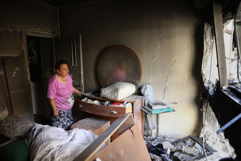 Julianna Sror views the damage to her apartment on May 13 after it was hit by a rocket in Petah Tikva, Israel.