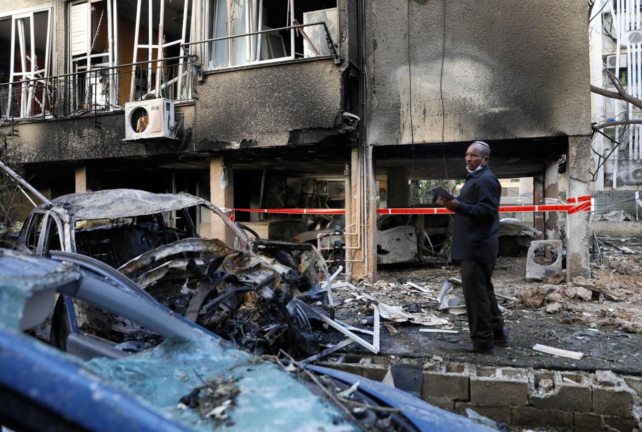 A man checks damage following a rocket attack in the central Israeli city of Petah Tikva on May 13.