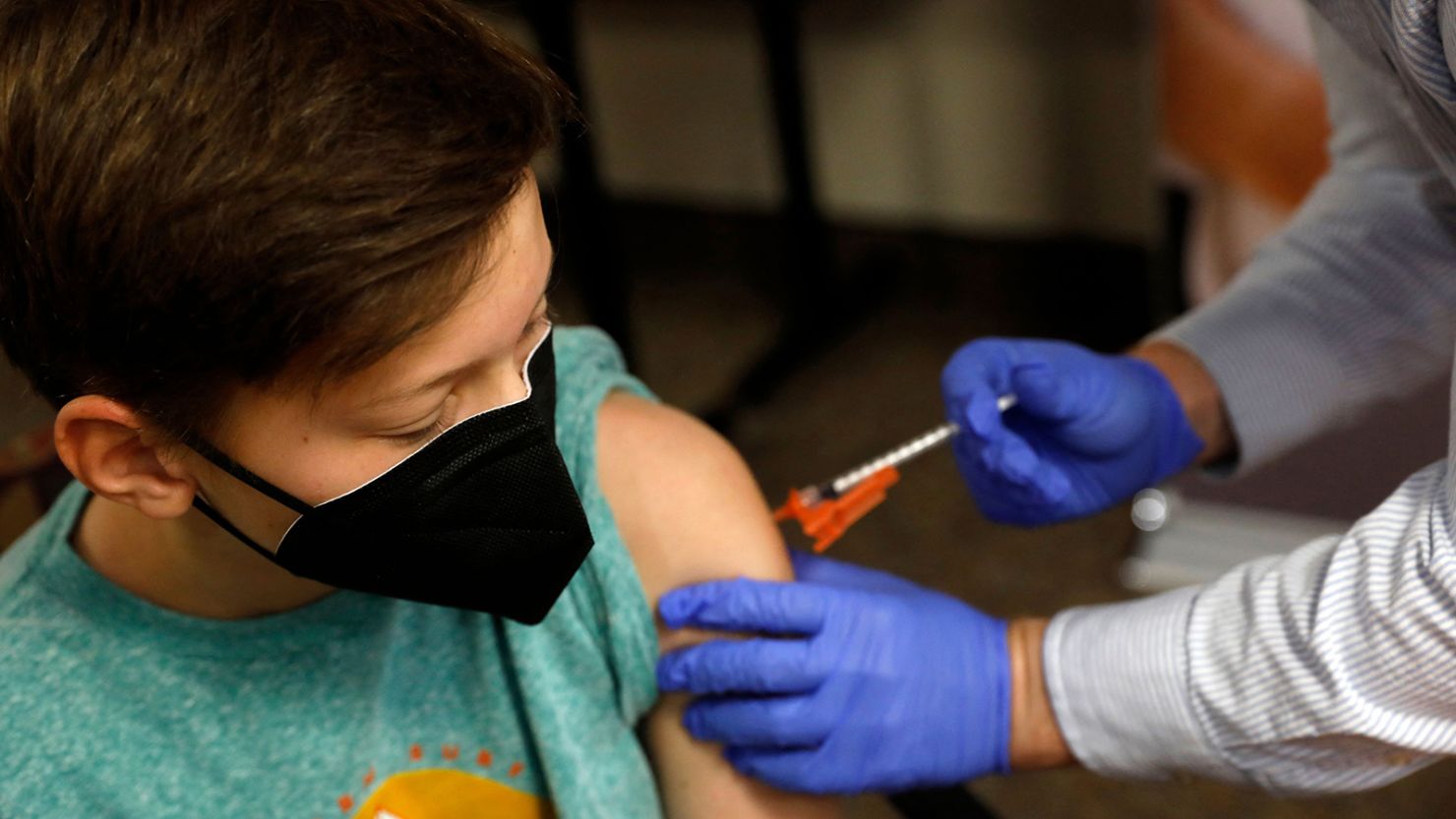 Aiden Arthurs receives the Pfizer-BioNTech Covid-19 Vaccine from Pharmacist Andrew Mac (R) at the Jewish Federation/JARC's offices in Bloomfield Hills, Michigan, on May 13, 2021. - The US Food and Drug Administration (FDA) on May 10, 2021 authorized the use of the Pfizer-BioNTech Covid-19 vaccine for children aged 12 to 15 years old. (Photo by JEFF KOWALSKY / AFP) (Photo by JEFF KOWALSKY/AFP via Getty Images)