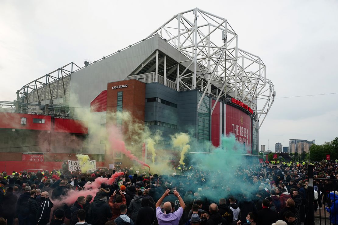 Manchester United fans let off flares as they protest against the Glazer family.