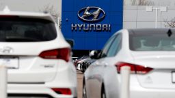 In this March 29, 2018, photo the company logo hangs over a line of unsold 2018 vehicles on the lot of a Hyundai dealership in Littleton, Colo. U.S. auto sales grew 6.3 percent in March on rising sales of SUVs and pickup trucks. (AP Photo/David Zalubowski)