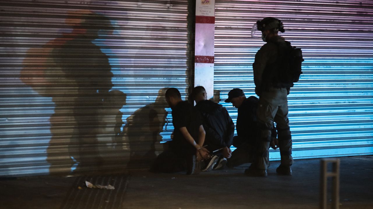 An Israeli security soldier detains three Arabs during clashes between Jews, Arabs and police in Lod on May 13.