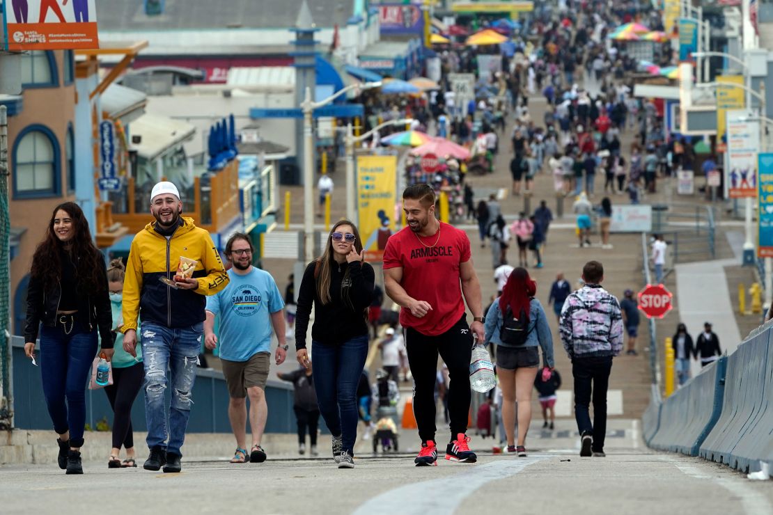 Pedestrians walk on the pier in Santa Monica, California, on May 13, when the CDC announced vaccinated people can go maskless in most outdoor and indoor settings.