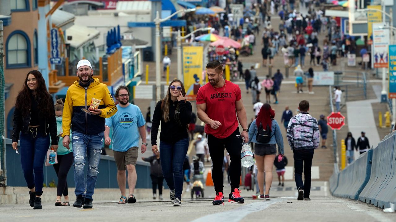 Pedestrians walk on the pier in Santa Monica, California, on May 13, when the CDC announced vaccinated people can go maskless in most outdoor and indoor settings.