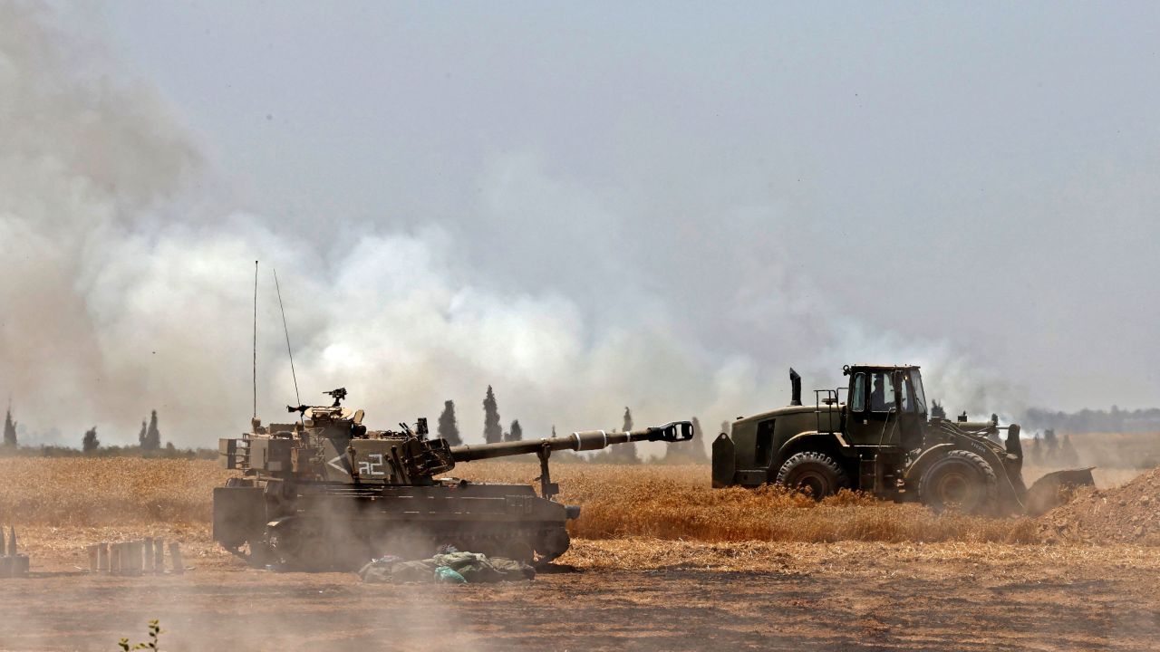 Israeli soldiers fire artillery shells towards Gaza from their position near the southern Israeli city of Sderot on May 14.