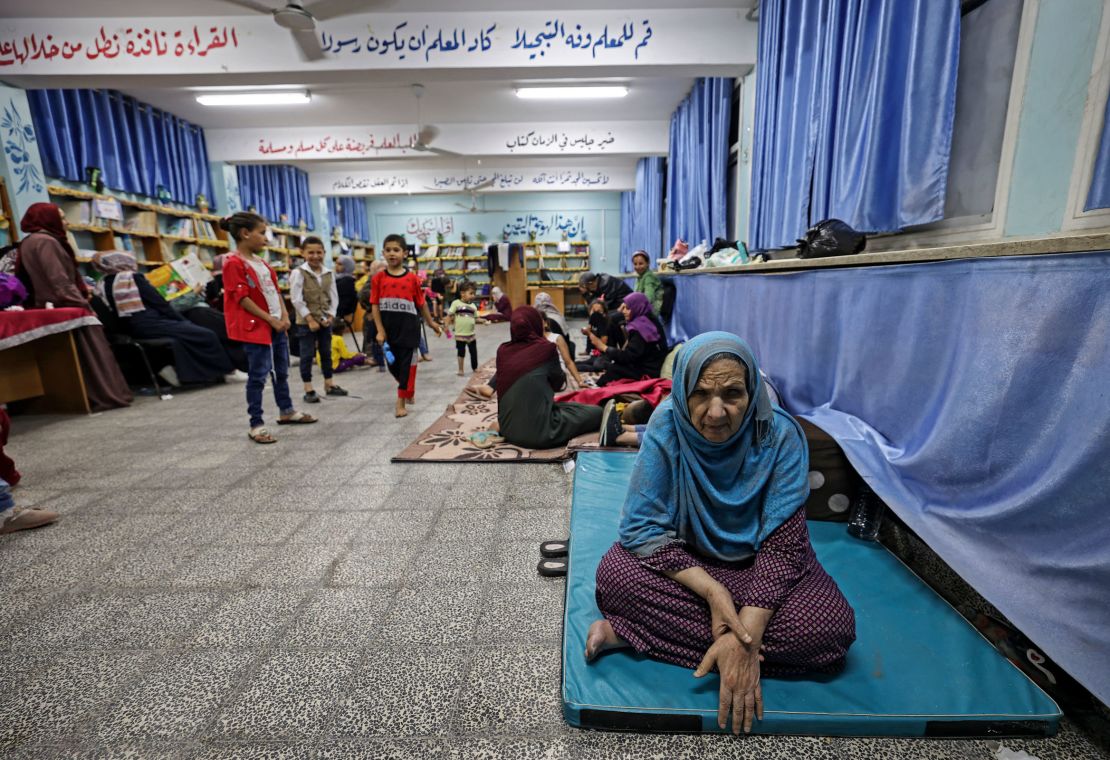 Palestinian families take shelter in a UN school in Gaza City on May 13, after fleeing from their homes in the town of Beit Lahia.