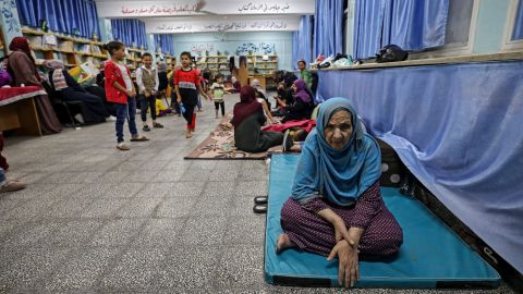 Palestinian families take shelter in a UN school in Gaza City on May 13, after fleeing from their homes in the town of Beit Lahia.