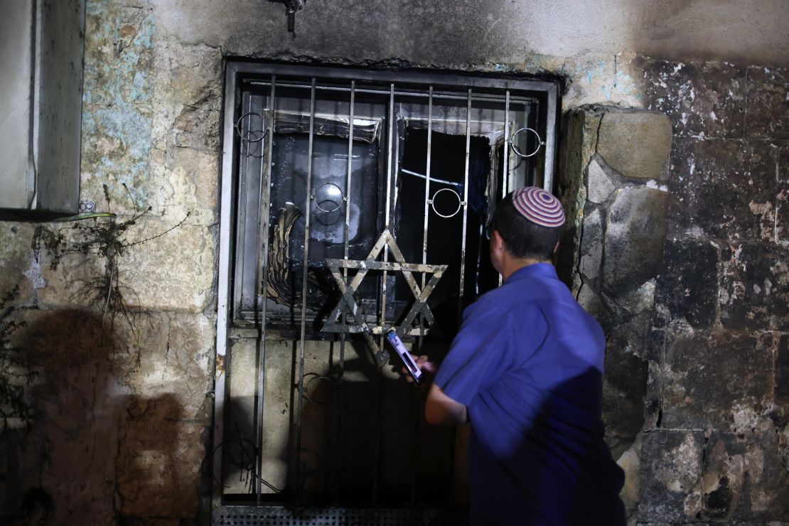 An Israeli man looks inside a synagogue after it was set on fire by Arab-Israelis in the city of Lod, Israel, on May 14.