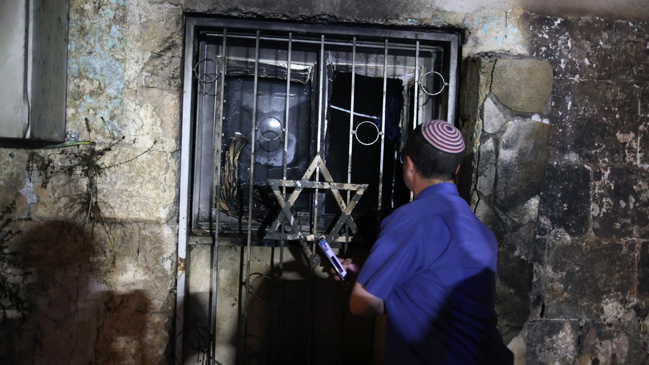An Israeli man looks inside a synagogue after it was set on fire by Arab-Israelis in the city of Lod, Israel, on May 14.