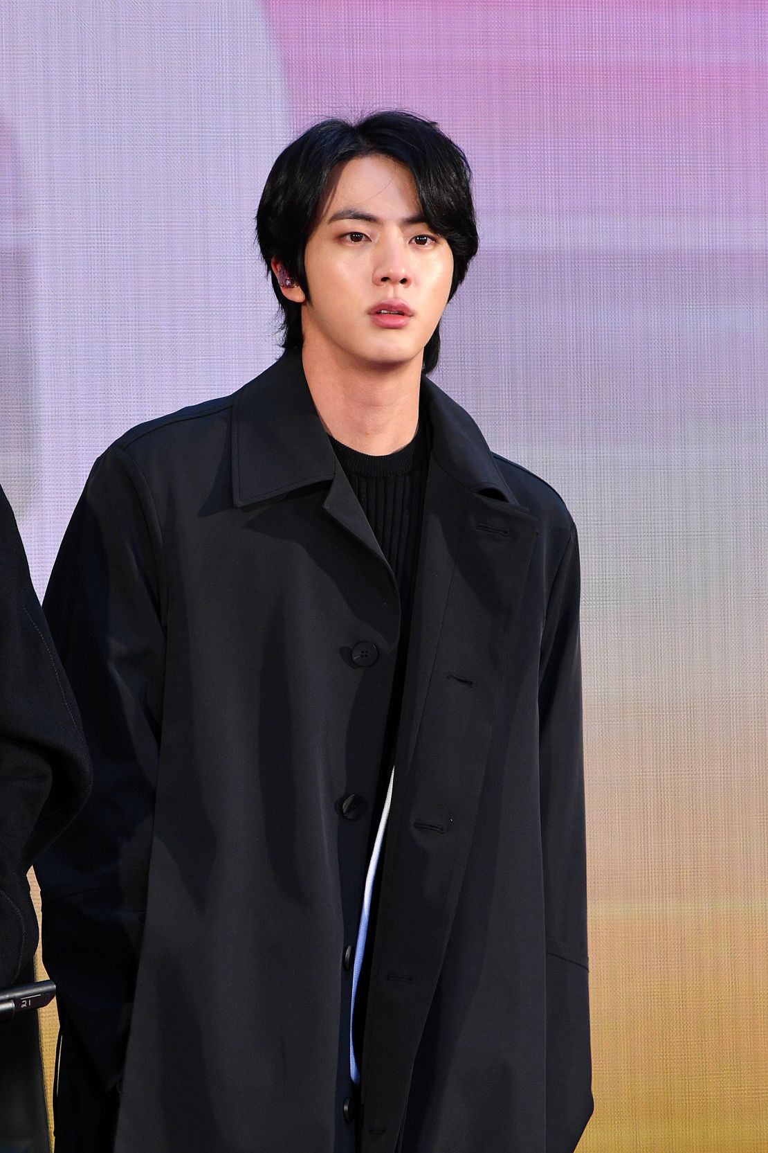 Jin, a member of K-pop boy band BTS, has a shapely wolf cut style with long tapered layers and a trailing tail.
